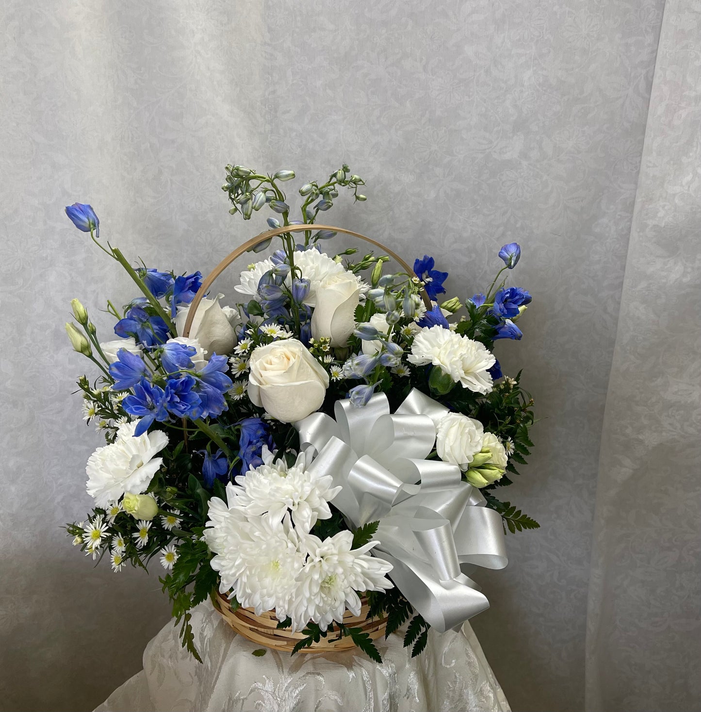 P Blue and white basket centerpiece – Pequa Park Florists Inc, Massapequa NY