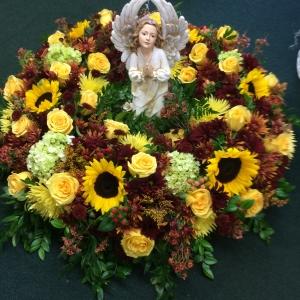 Urn arrangement with small angels –  Pequa Park Florists Inc, Massapequa NY